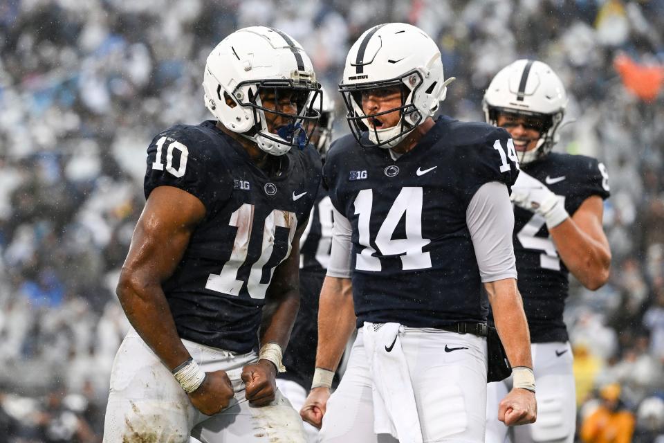 Penn State running back Nicholas Singleton (10) celebrates a touchdown with quarterback Sean Clifford (14) during the first half of an NCAA college football game against Northwestern, Saturday, Oct. 1, 2022, in State College, Pa. (AP Photo/Barry Reeger)