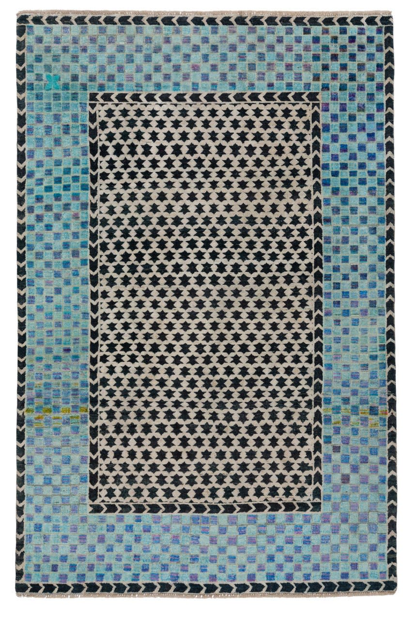 A full view of one rug, which juxtaposes bright turquoise hues with graphic black and white.