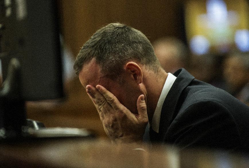 Oscar Pistorius cradles his head in his hands as he listens to evidence during his murder trial in Pretoria, South Africa, Thursday, May 8, 2014. Pistorius is charged with the shooting death of his girlfriend Reeva Steenkamp on Valentine's Day in 2013. (AP Photo/Gianluigi Guercia, Pool)