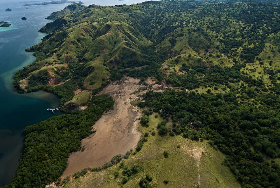 This undated photo provided by researcher Bryan Fry shows part of Komodo National Park in Indonesia. Encompassing about 850 square miles (2,200 square kilometers) of land and marine area, the park was established in 1980 to help protect the famed dragons. Indonesia's Ministry of Environment and Forestry estimates around 3,000 of the reptiles live there today, along with manatee-like dugongs, sea turtles, whales and more than a thousand species of tropical fish. (Bryan Fry via AP)