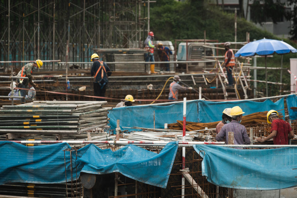Migrant workers wearing protective masks at a construction site in Singapore, Tuesday, 31 August, 2021. Daily local cases continue to rise as virus clusters linked to public bus interchanges emerge. Singapore announced an 80% vaccination rate last week. (Photo by Joseph Nair/NurPhoto via Getty Images)