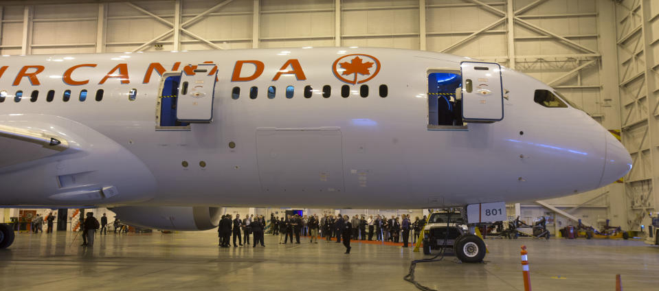 Visitors wait to get on board to view the interior of a newly delivered Boeing 787 Dreamliner at Pearson Airport on May 20, 2014. (Chris So/Toronto Star via Getty Images)