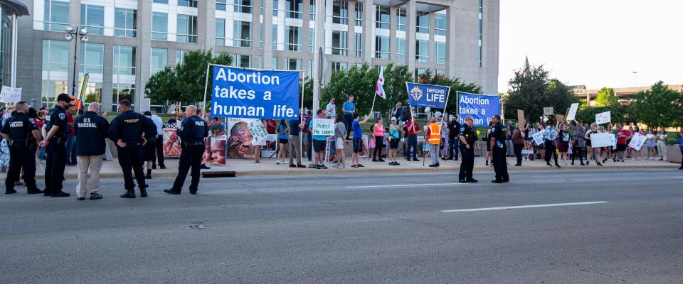 Abortion-rights and anti-abortion protesters gather outside of the Stanley J. Roszkowski United States Courthouse on Friday, June 24, 2022, in Rockford.