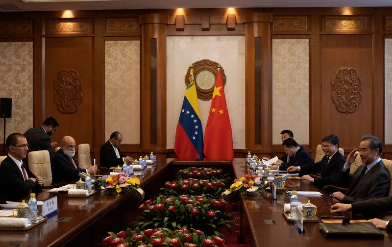 Chinese Foreign Minister Wang Yi salutes during a meeting with Venezuela's Foreign Minister Jorge Arreaza at the Diaoyutai State Guest House in Beijing