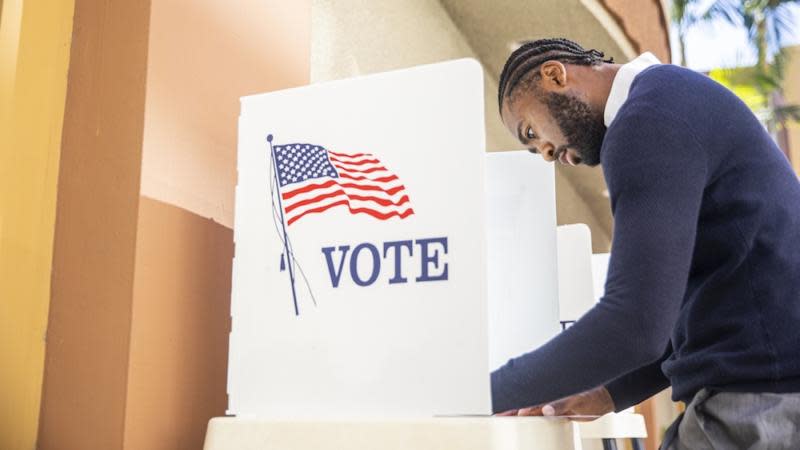 Black man at voting booth. | Photo: Getty Images