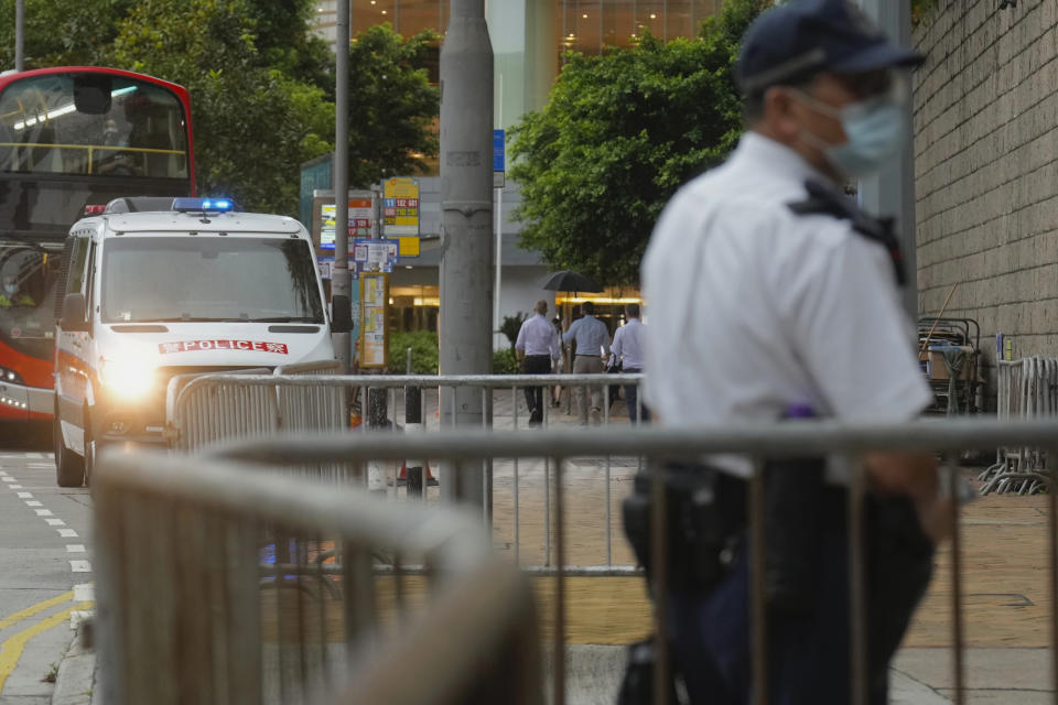 A police officer stands guard while waiting for Tong Ying-kit's arrival at the Hong Kong High Court in Hong Kong Friday, July 30, 2021. Tong Ying-kit was convicted Tuesday of inciting secession and terrorism for driving his motorcycle into a group of police officers during a July 1, 2020, pro-democracy rally while carrying a flag bearing the banned slogan, "Liberate Hong Kong, revolution of our times." Tong, 24, will be sentenced Friday, the court announced. (AP Photo/Vincent Yu)
