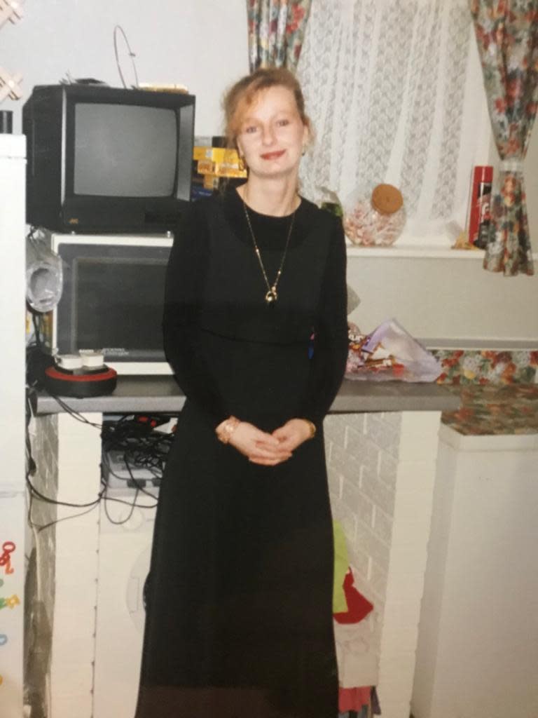 Bee Wickert-Leng before her first breast implant surgery wearing a long black dress