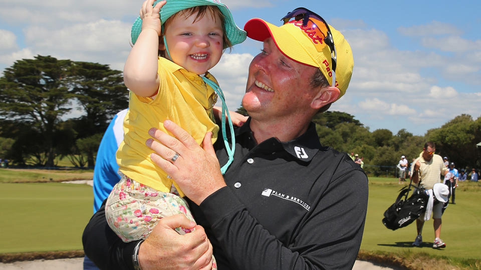 Jarrod Lyle hugs his daughter Lusi on the 18th green after completing his round during round four of the 2013 Australian Masters at Royal Melbourne Golf Course on November 17, 2013 in Melbourne, Australia. (Photo by Scott Barbour/Getty Images)