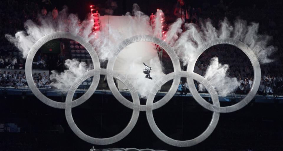 <p>No malfunctions here! Vancouver opened the Games with a snowboarder jumping through the Olympic rings. (AP) </p>