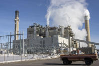 Steam billows from stacks at the Naughton Power Plant, Wednesday, Jan. 12, 2022 in Kemmerer, Wyo. While the power plant will be closed in 2025, TerraPower announced Kemmerer will be the site of a demonstration nuclear reactor. (AP Photo/Natalie Behring)