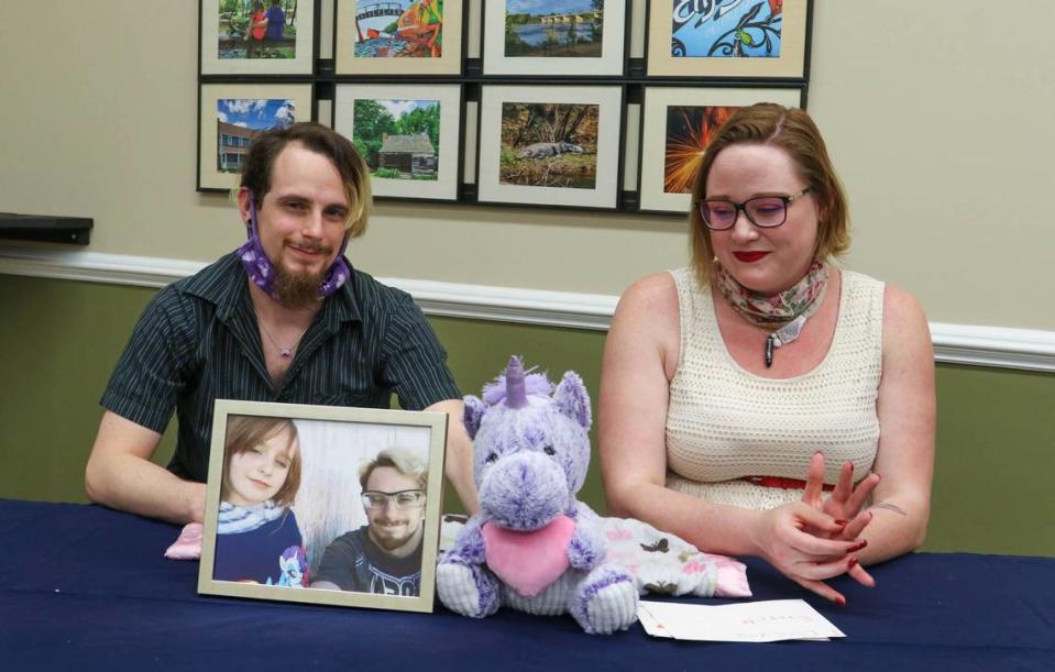 Faye Swetlik’s mother, Selena Collins and father Chad Swetlik sit with a portrait of Faye Swetlik and a purple unicorn they purchased her for Valentine’s Day. Faye was abducted from her yard in Cayce in February, 2020, and later killed.