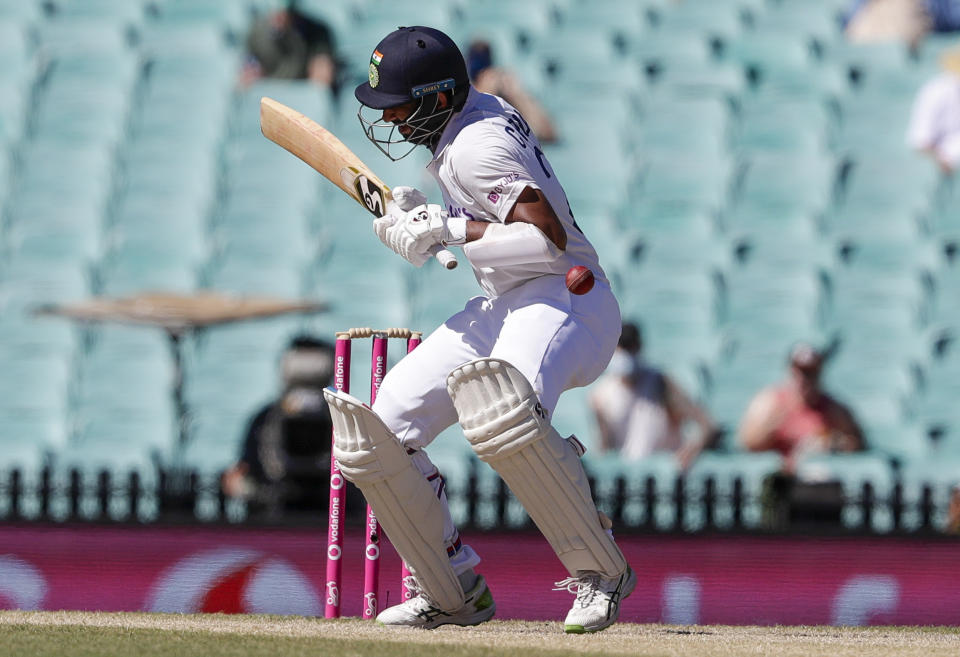 India's Cheteshwar Pujara reacts as he is hit while batting during play on the final day of the third cricket test between India and Australia at the Sydney Cricket Ground, Sydney, Australia, Monday, Jan. 11, 2021. (AP Photo/Rick Rycroft)