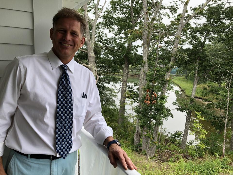 John Martin, of The Colony in Kennebunkport, Maine, shows the balcony view of the cove behind new lodging currently under construction on the hotel's north campus. The new, three-part structure is expected to be finished in the fall of 2023.