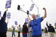 Members of the United Auto Workers strike outside of a John Deere plant, Wednesday, Oct. 20, 2021, in Ankeny, Iowa. About 10,000 UAW workers have gone on strike against John Deere since last Thursday at plants in Iowa, Illinois and Kansas. (AP Photo/Charlie Neibergall)