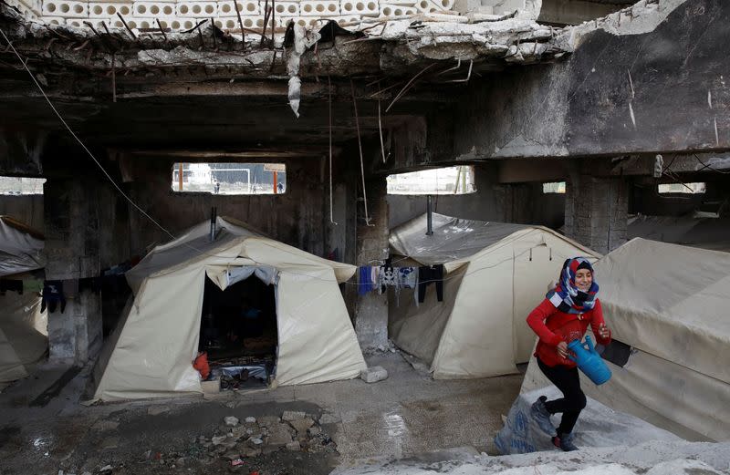 FILE PHOTO: An internally displaced Syrian girl steps up the stairs in an IDP camp located in Idlib