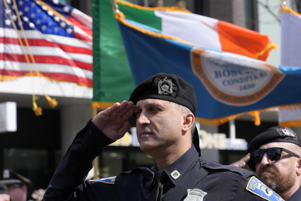 A member of the Boston Police Gaelic Column of Pipes and Drums salutes during the singing of the National Anthem before the Patrick's Day parade, Sunday, March 17, 2024, in Boston's South Boston neighborhood. (AP Photo/Steven Senne)