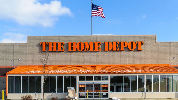 "Wareham, Massachusetts, USA-January 7, 2013: An American flag flies over the entrance and outside facade of a large Home Depot store that sells a full range of building matrerials and home products.