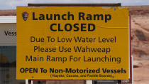 FILE - A "Launch Ramp Closed" sign is shown at the Antelope Point launch ramp on Lake Powell on July 31, 2021, near Page, Ariz., after water levels hit a historic low amid a climate change-fueled megadrought engulfing the U.S. West. Federal water officials have announced that they will keep hundreds of billions of gallons of Colorado River water inside Lake Powell instead of letting it flow downstream to southwestern states and Mexico. U.S. Assistant Secretary of Water and Science Tanya Trujillo said Tuesday, May 3, 2022, that the move would allow the Glen Canyon Dam to continue producing hydropower while officials strategize how to operate the dam with a lower water elevation. (AP Photo/Rick Bowmer, File)