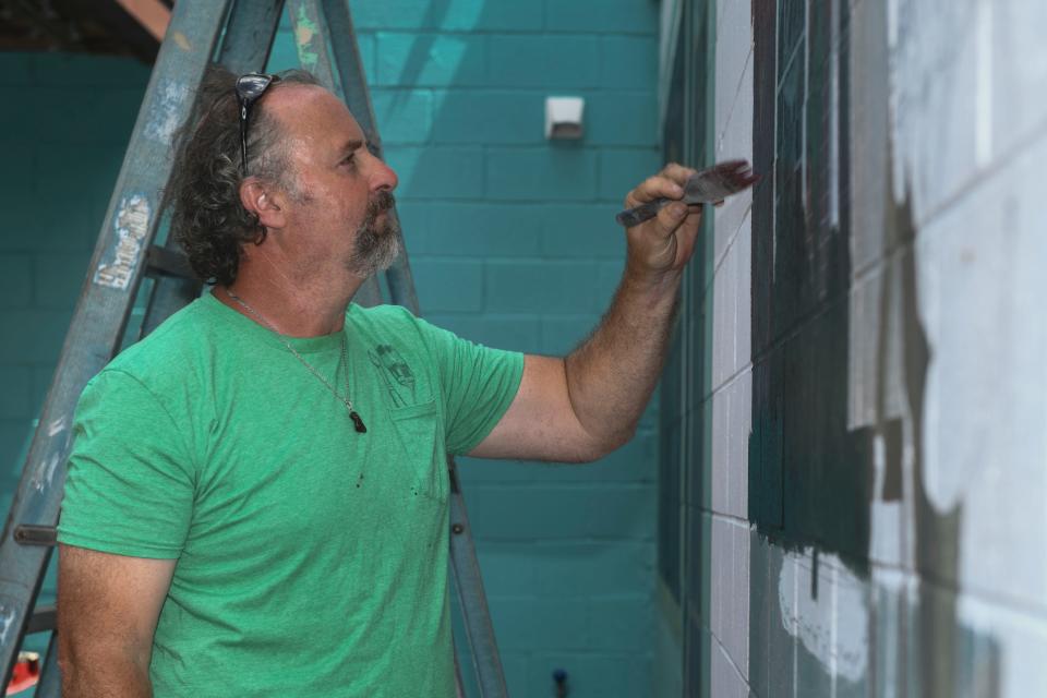 Brian Stewart paints a new mural on the side of the 523 Gallery in Augusta, Ga., on Thursday, Aug. 17, 2023. 