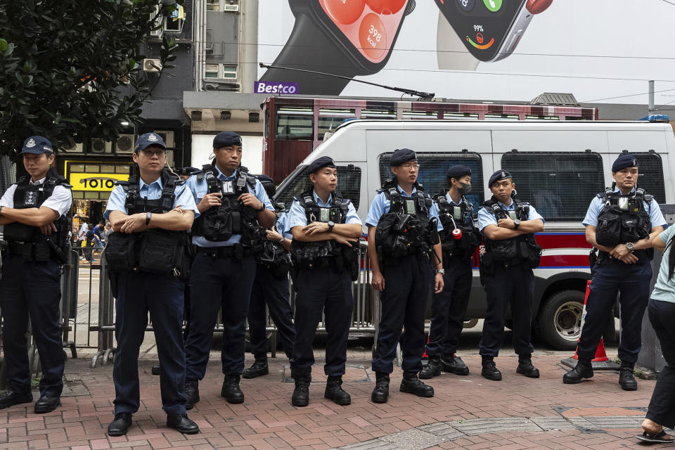 Police officers stand guard in the Causeway Bay area on the 35th anniversary of China's Tiananmen Square crackdown in Hong Kong, Tuesday, June 4, 2024. (AP Photo/Chan Long Hei)