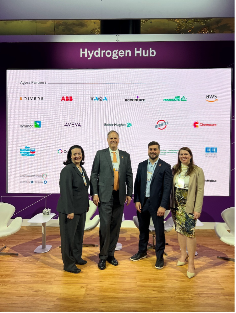 Stefanie Kopchick, Bill Raiford, Chris Warren, and Catherine Collison in front of the Hydrogen Hub stage at CERAWeek