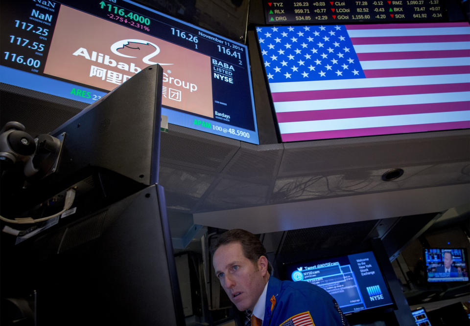 Trader Glenn Carell works at the post that trades Alibaba on the floor of the New York Stock Exchange November 11, 2014.  REUTERS/Brendan McDermid