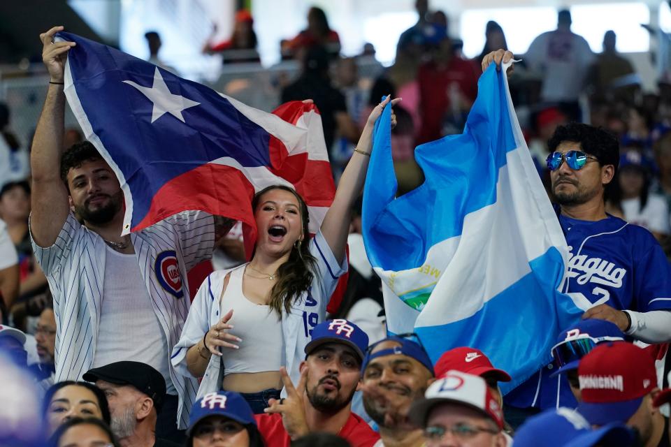 Nicaraguan and Puerto Rican fans cheer their team during a World Baseball Classic game, Saturday, March 11, 2023, in Miami. (AP Photo/Marta Lavandier)