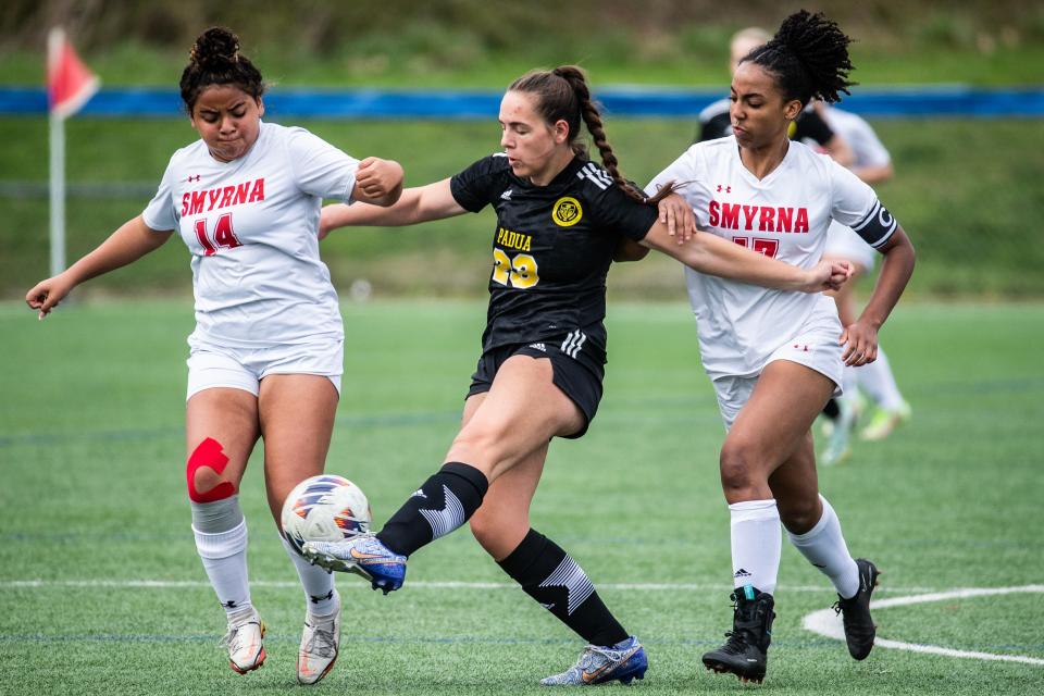 Padua Academy sophomore Alexis Greenjack (23) battles for the ball against Smyrna High School sophomore Jocelyn Tejeda (14) and junior Desiree Zapata (17) during the girls soccer game at the Hockessin Soccer Club, Monday, April 3, 2023. Padua won 6-0.