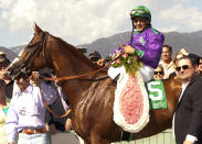 In a photo provided by Benoit Photo, California Chrome and jockey Victor Espinoza pose in the winner's circle after victory in the Santa Anita Derby horse race Saturday, April 5, 2014, at Santa Anita in Arcadia, Calif. (AP Photo/Benoit Photo)