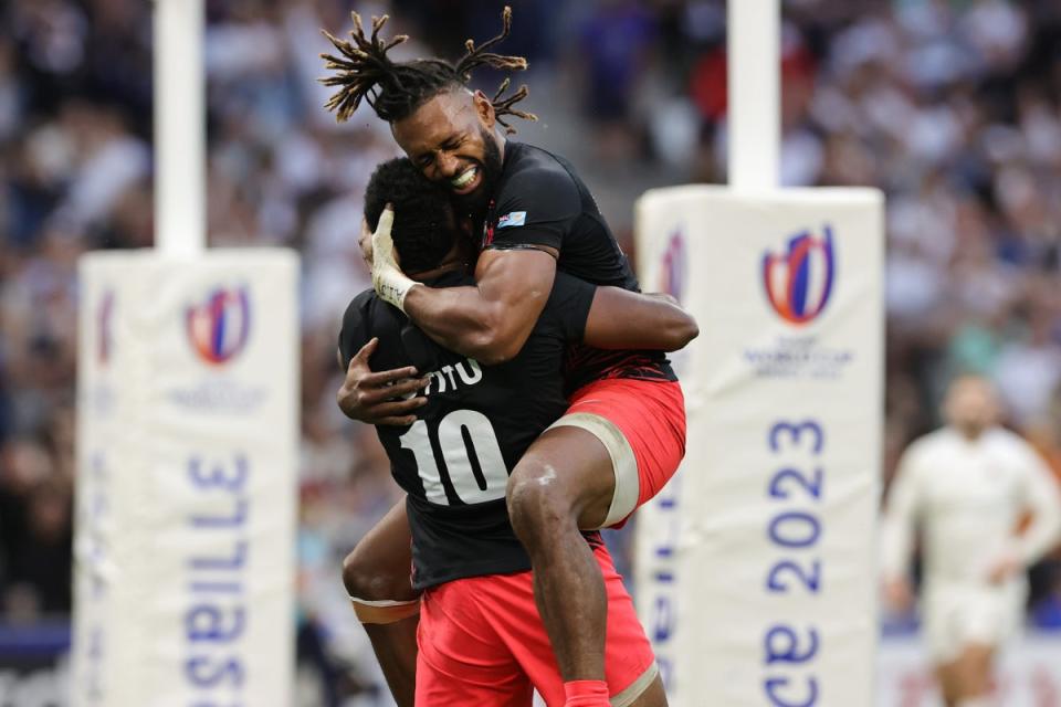 Captain Waisea Nayacalevu embraces Vilimoni Botitu after the fly half’s try against England  (Getty Images)