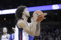 Gonzaga forward Anton Watson, front, drives to the basket while defended by Kentucky guard CJ Fredrick during the first half of an NCAA college basketball game, Sunday, Nov. 20, 2022, in Spokane, Wash. (AP Photo/Young Kwak)