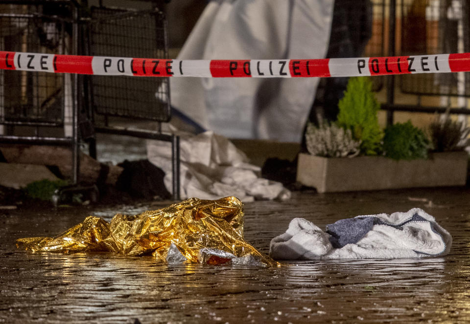 Evidence lies at the scene of an incident in Trier, Germany, Tuesday, Dec. 1, 2020. German police say people have been killed and several others injured in the southwestern German city of Trier when a car drove into a pedestrian zone. Trier police tweeted that the driver had been arrested and the vehicle impounded.(AP Photo/Michael Probst)