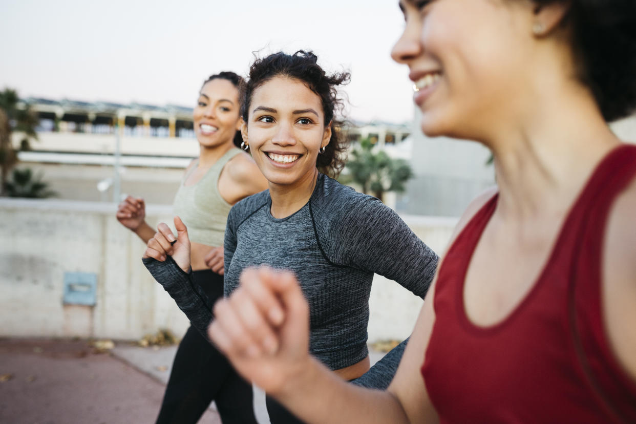 Three women running together.