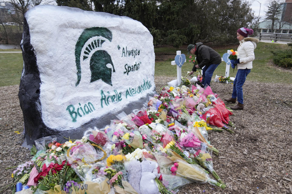 Mourners leave flowers at The Rock on the grounds of Michigan State University in East Lansing, Mich., Wednesday, Feb. 15, 2023. Alexandria Verner, Brian Fraser and Arielle Anderson were killed and several other students remain in critical condition after a gunman opened fire on the campus of Michigan State University Monday night. (AP Photo/Paul Sancya)