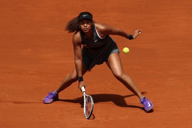 Naomi Osaka of Japan stretches for a forehand in her first round match against Misaki Doi of Japan during day two of the Mutua Madrid Open Tennis at La Caja Magica on April 30, 2021 in Madrid, Spain. (Clive Brunskill/Getty Images - image credit)