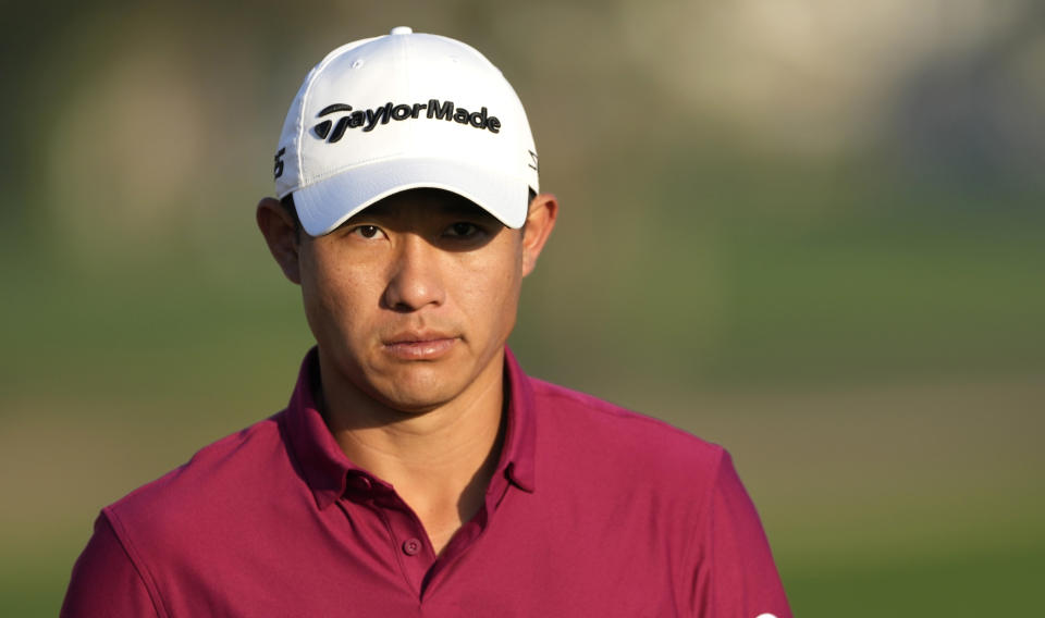 Colin Morikawa of the U.S. walks on the 10th hole during first round of the Dubai Desert Classic golf tournament in Dubai, United Arab Emirates, Thursday, Jan. 27, 2022. (AP Photo/Kamran Jebreili)