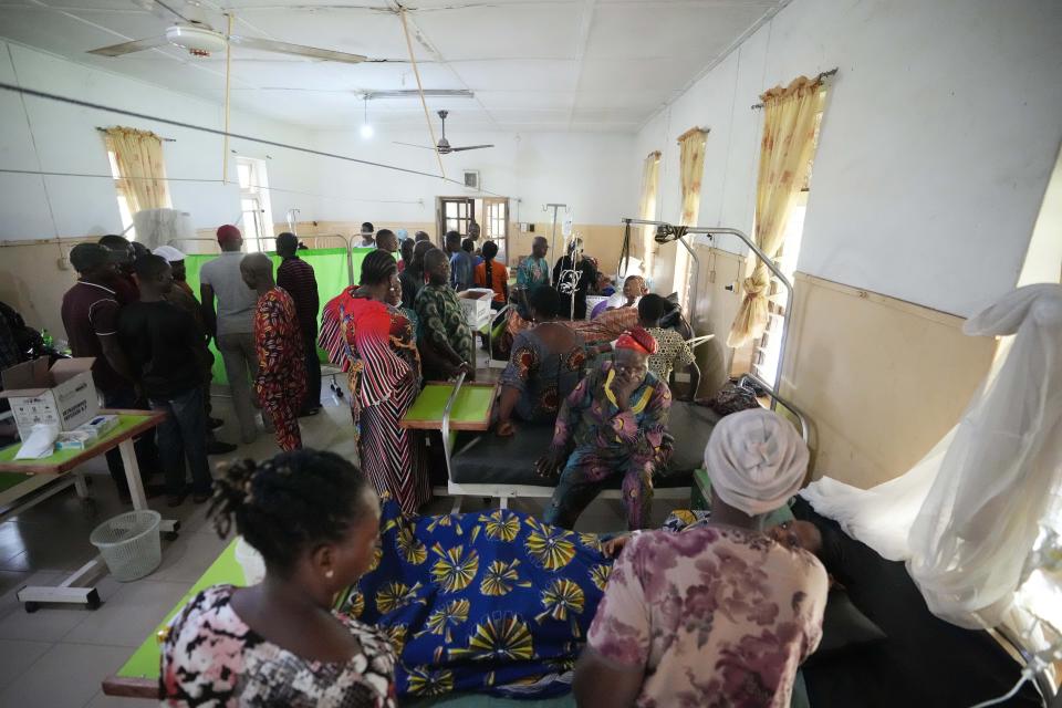 People visit victims of St. Francis Catholic Church attack as they receive treatment at the St Louis Catholic hospital in Owo, Nigeria, Monday, June 6, 2022. Lawmakers in southwestern Nigeria say more than 50 people are feared dead after gunmen opened fire and detonated explosives at a church. Ogunmolasuyi Oluwole with the Ondo State House of Assembly said the gunmen targeted the St Francis Catholic Church in Ondo state on Sunday morning just as the worshippers gathered for the weekly Mass. (AP Photo/Sunday Alamba)