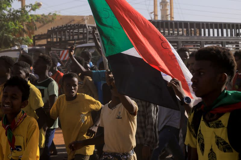 Protesters march during a rally marking the anniversary of the April uprising, in Khartoum