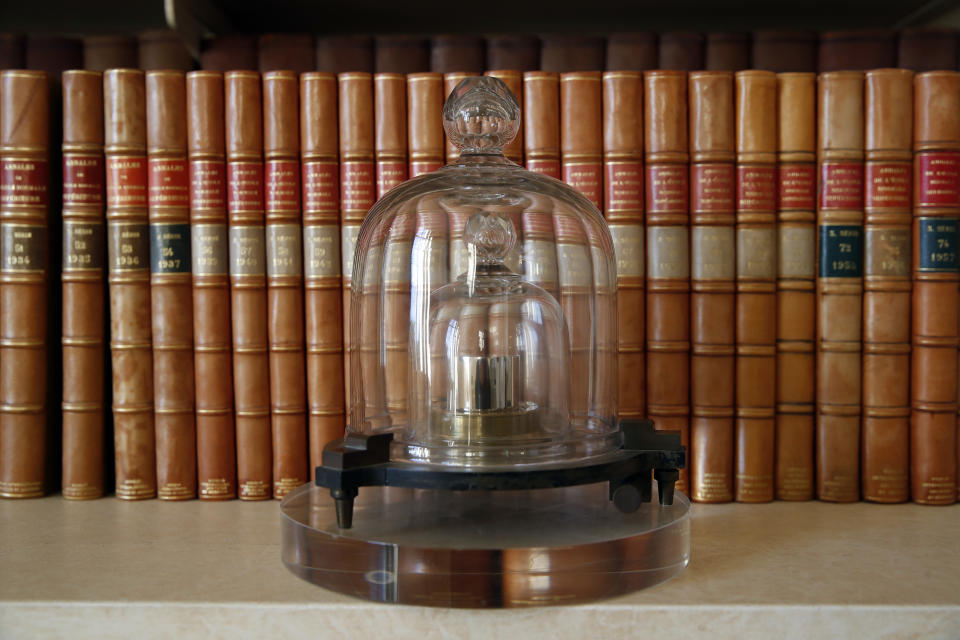 In this photo taken Wednesday, Oct. 17, 2018., a replica of the International Prototype Kilogram is pictured at the International Bureau of Weights and Measures, in Sevres, near Paris. The golf ball-sized metal cylinder at the heart of the world's system for measuring mass is heading into retirement. Gathering this week in Versailles, west of Paris, governments on Friday Nov. 16, 2018, are expected to approve a plan to instead use a scientific formula to define the exact weight of a kilo. (AP Photo/Christophe Ena)