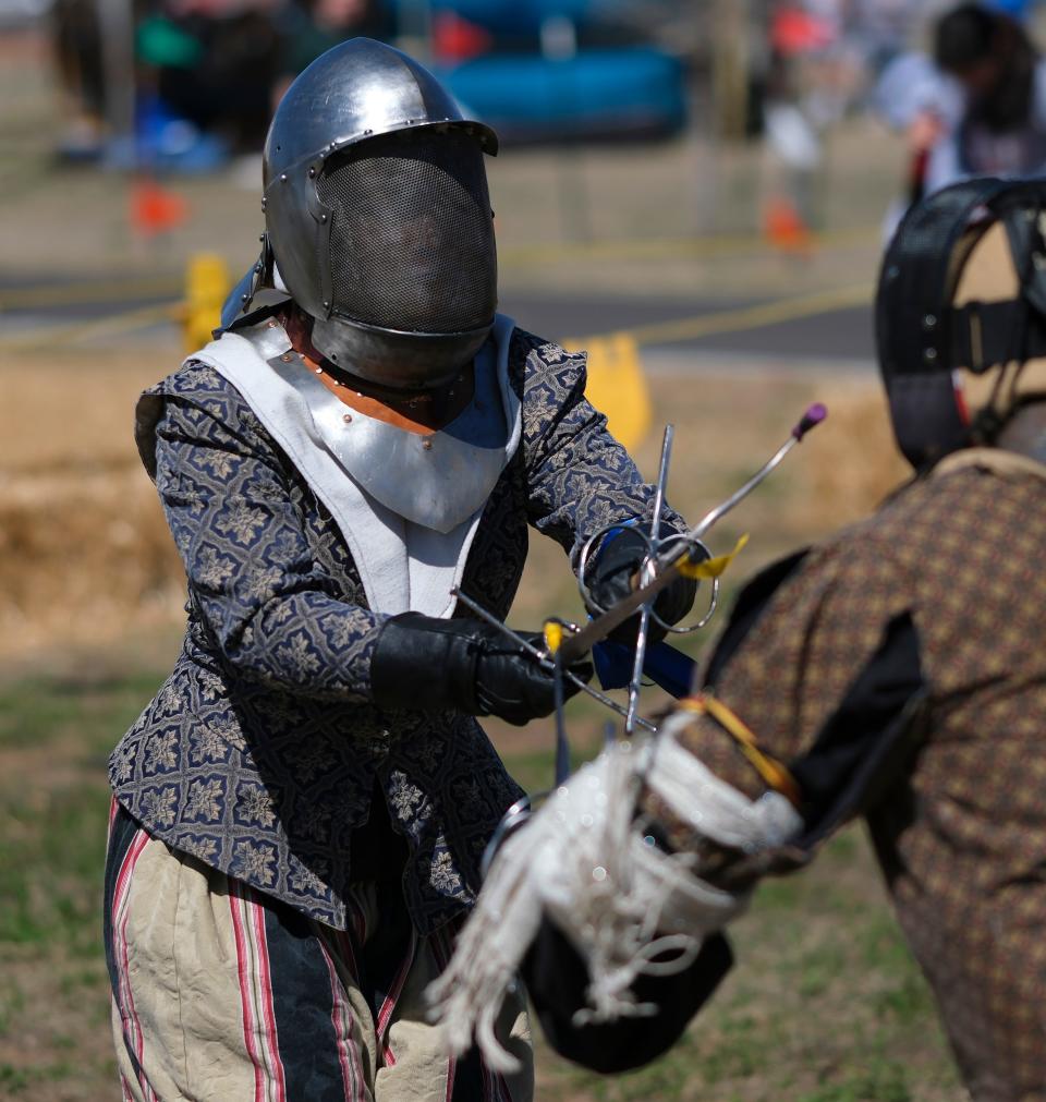 Maryann Childress does a combat demonstration with daggers March 31, 2023, during the Medieval Fair at Reaves Park in Norman.