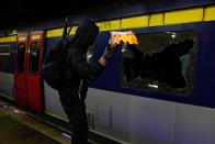 An anti-government protester throws a Molotov cocktail at the MTR University station during a protest at the Chinese University of Hong Kong, Hong Kong