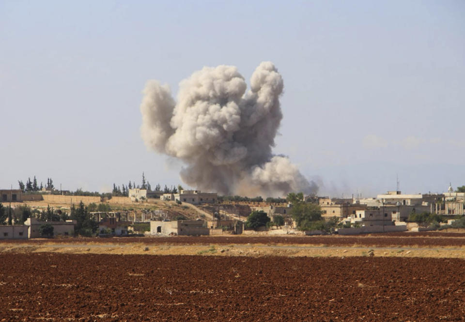 This photo released on Monday, Sept. 10, 2018 by the Syrian Civil Defense group known as the White Helmets, shows smoke rising from a Syrian government airstrike, in Hobeit village, near Idlib, Syria. High-level diplomats from Iran, Russia and Turkey were meeting Tuesday with the U.N. envoy for Syria about creating a committee to revise the war-battered country's constitution. Tuesday's talks in Geneva under U.N. envoy Staffan de Mistura come amid concerns he and other U.N. officials have expressed about a looming battle for Idlib. (Syrian Civil Defense White Helmets via AP)