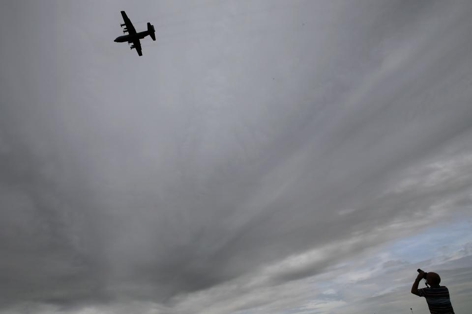 An aviation enthusiast photographs an Airbus A400M aircraft during the The Royal International Air Tattoo at the RAF in Fairford