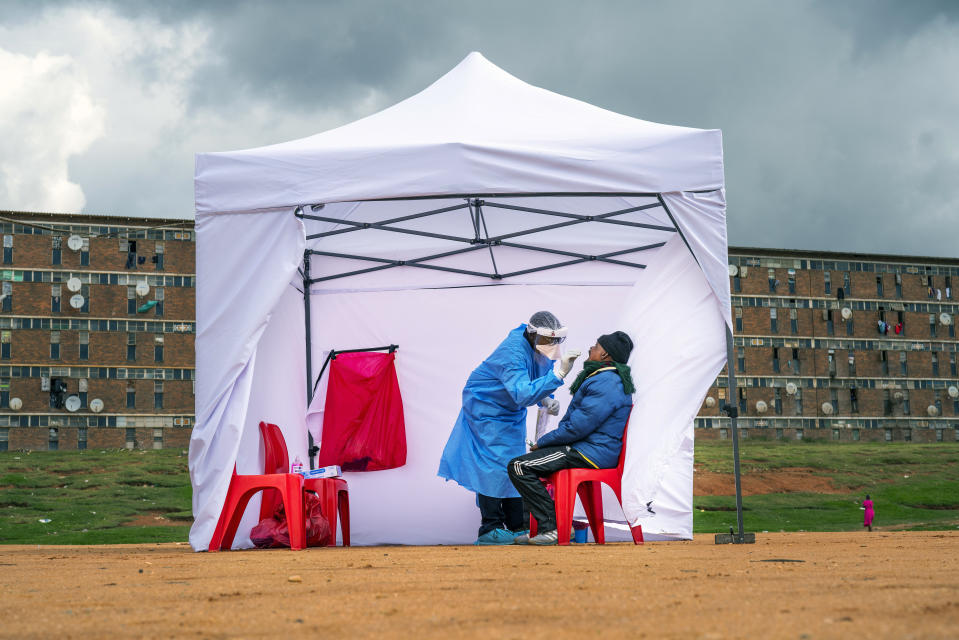 FILE - A resident from the Alexandra township gets tested for COVID-19 , in Johannesburg, Wednesday, April 29, 2020. A new coronavirus variant has been detected in South Africa that scientists say is a concern because of its high number of mutations and rapid spread among young people in Gauteng, the country's most populous province. (AP Photo/Jerome Delay, File)