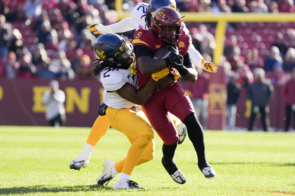Iowa State running back Cartevious Norton (5) is tackled by West Virginia defensive back Aubrey Burks (2) after catching a pass during the first half of an NCAA college football game, Saturday, Nov. 5, 2022, in Ames, Iowa. (AP Photo/Charlie Neibergall)