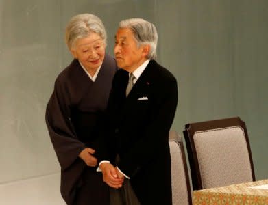 Japan's Empress Michiko talks to Emperor Akihito as he looks at an altar for the war dead during a memorial ceremony marking the 72nd anniversary of Japan's surrender in World War Two, at Budokan Hall in Tokyo, Japan August 15, 2017.  REUTERS/Kim Kyung-Hoon