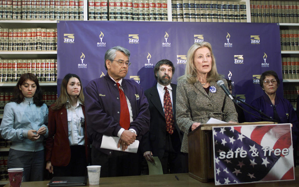 FILE - In this Jan. 17, 2002 file photo, Ramona Ripston, executive director of the American Civil Liberties Union of Southern California, at podium, announces a legal challenge to the recently enacted Aviation and Transportation Security Act, which denies qualified, lawful, permanent residents of the United States the opportunity to continue employment as screeners because they are not at the moment citizens, at the ACLU/SC in Los Angeles. Ripston, a longtime activist who built up the American Civil Liberties Union of Southern California into a major organization, has died at age 91. Ripston died Saturday, Nov. 3, 2018, at her home after several years of illness, said David Colker, a spokesman for the chapter. (AP Photo/Damian Dovarganes, File)