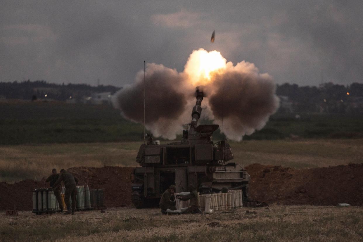 An Israeli artillery unit fires toward targets in the Gaza Strip, at the Israeli Gaza border, on Monday, May 17, 2021.