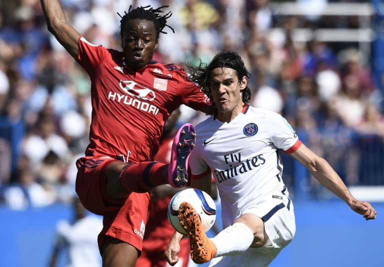 Paris Saint-Germain's Uruguayan forward Edinson Cavani (R) vies with Lyon's French Burkinabe defender Bakary Kone during the French Trophy of Champions football match in Montreal on August 1, 2015