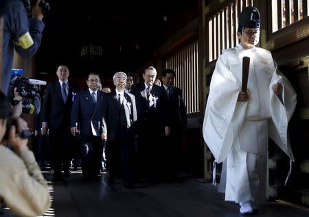 A group of lawmakers including Japan's ruling Liberal Democratic Party (LDP) lawmaker Hidehisa Otsuji (C) are led by a Shinto priest as they visit Yasukuni Shrine in Tokyo April 22, 2015. REUTERS/Toru Hanai